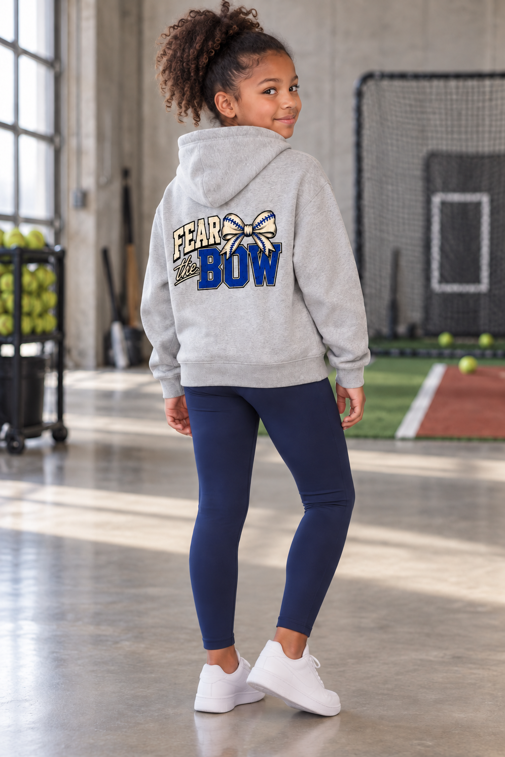 Girl wearing the Flower Gray Fear the Bow youth hoodie, back view
