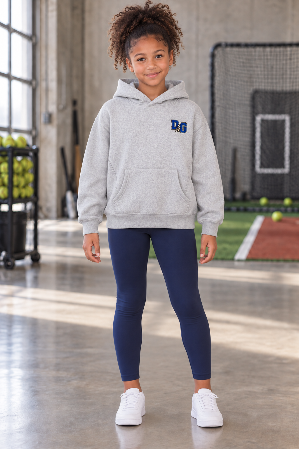 Girl wearing the Flower Gray Fear the Bow youth softball hoodie