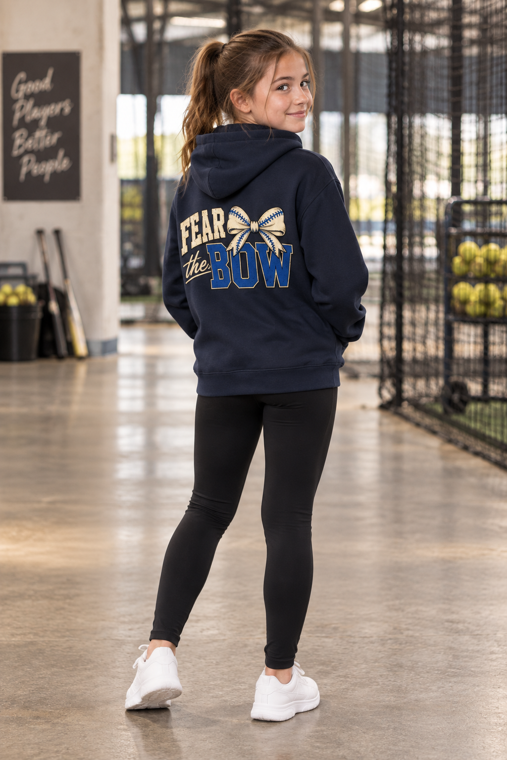 Girl wearing the Navy Blue Fear the Bow youth hoodie, back view